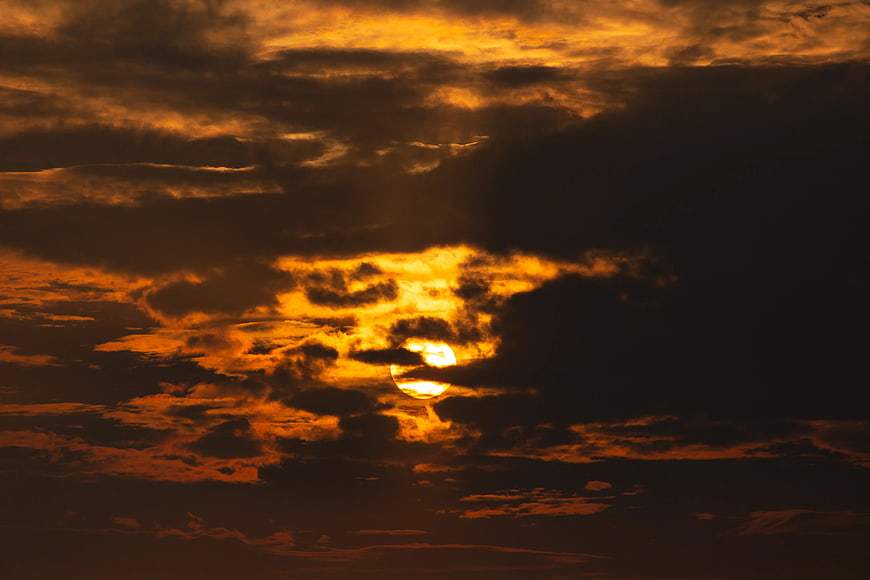 Dramatic Golden Sunset Sun Behind Dark Clouds