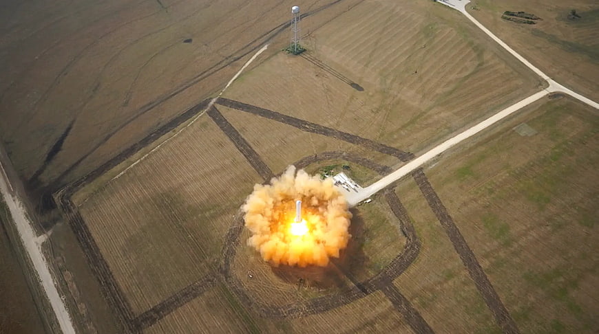 Aerial view of rocket launch with smoke plume