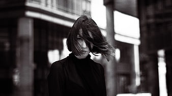 Black and white portrait of woman with windblown hair