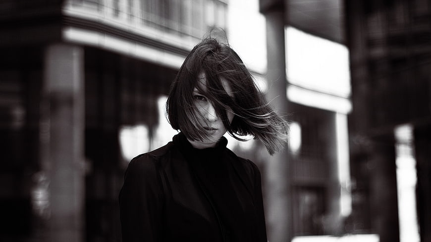 Black and white portrait of woman with windblown hair