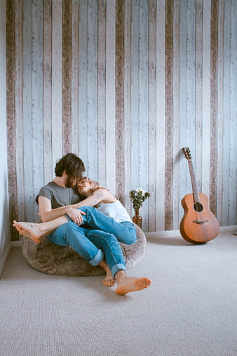 Couple Hugging on Beanbag Chair with Guitar
