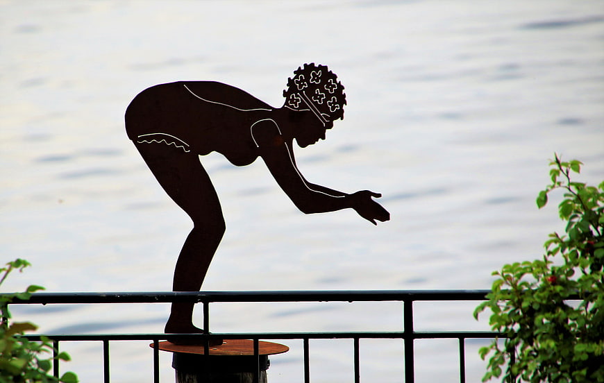 Metal Silhouette Sculpture of Woman by Lake