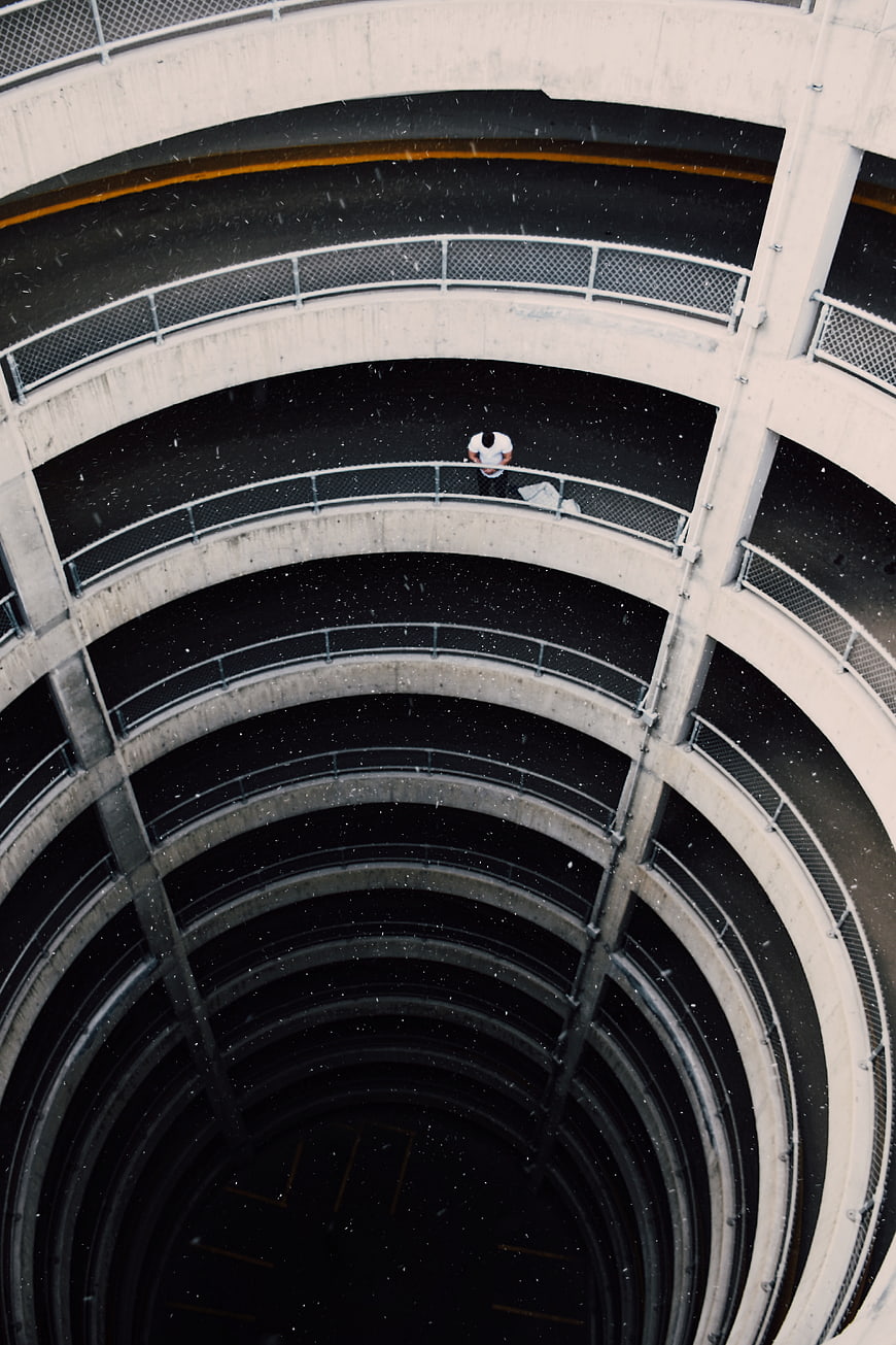 Aerial view of lone man in spiral parking garage