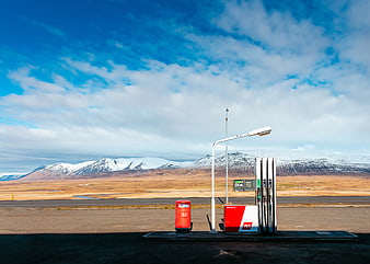 Lonely Gas Station in Icelandic Landscape with Snowy Mountains