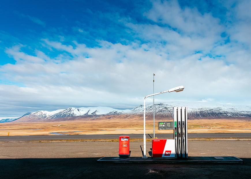 Lonely Gas Station in Icelandic Landscape with Snowy Mountains