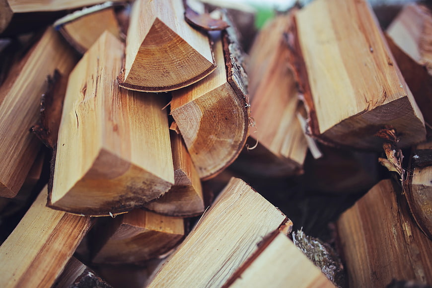 Close-up of stacked firewood logs with natural texture