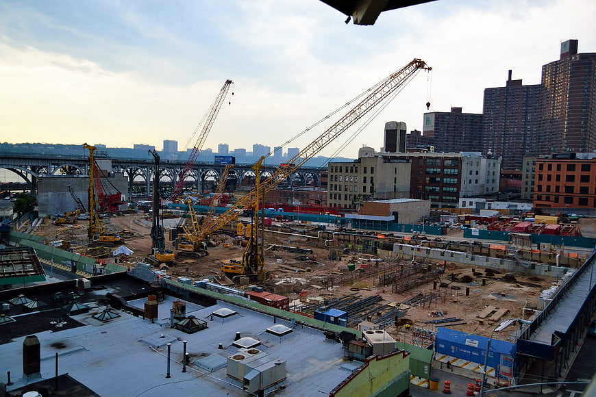 Urban Construction Site with Cranes and City Skyline