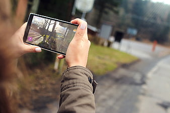 Woman Taking Photo with Smartphone Outdoors