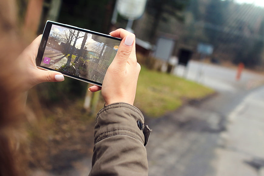 Woman Taking Photo with Smartphone Outdoors
