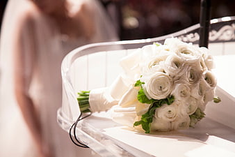 White Ranunculus Wedding Bouquet on Clear Chair