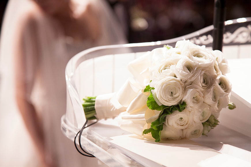 White Ranunculus Wedding Bouquet on Clear Chair