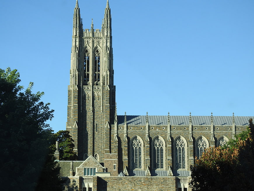 Gothic stone church tower against clear blue sky