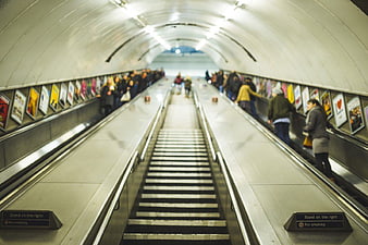 Commuters on Escalator in Underground Station