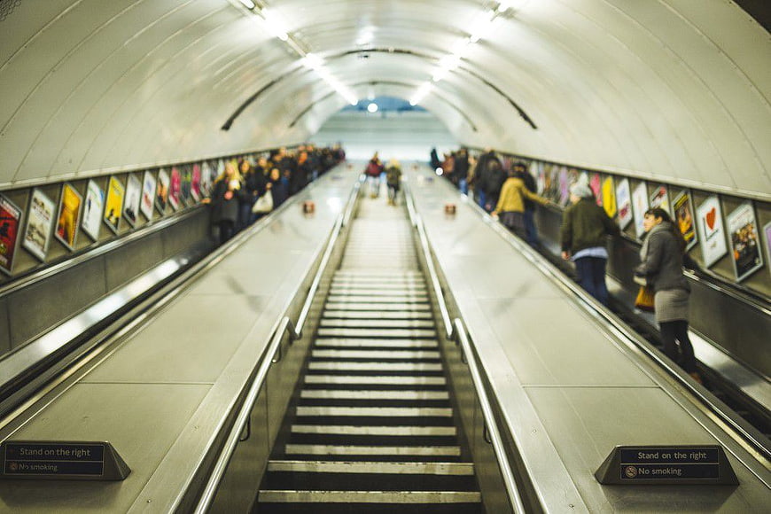 Commuters on Escalator in Underground Station