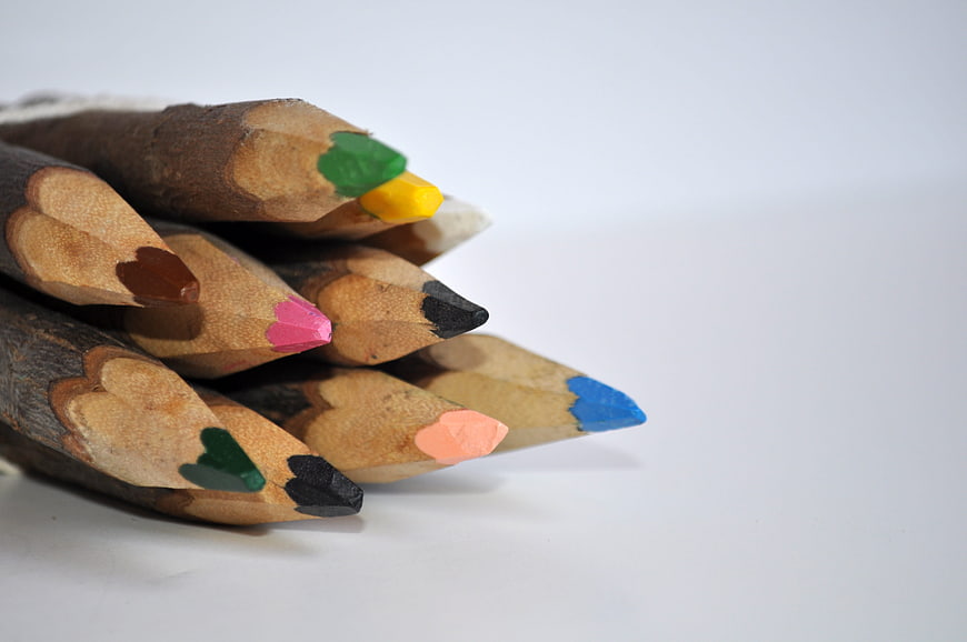 Close-up of colored pencil tips on white background