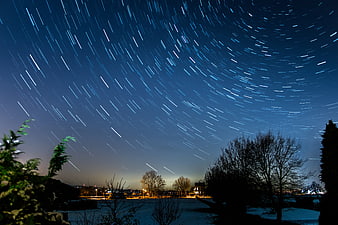 Star Trails Long Exposure Night Sky Over Snowy Winter Landscape
