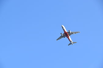 Commercial Airplane Flying in Blue Sky