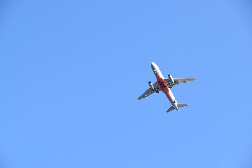 Commercial Airplane Flying in Blue Sky