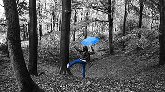 Woman with Blue Umbrella Dancing in Black and White Forest