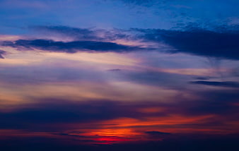 Dramatic sunset sky with vibrant purple, pink, and orange clouds