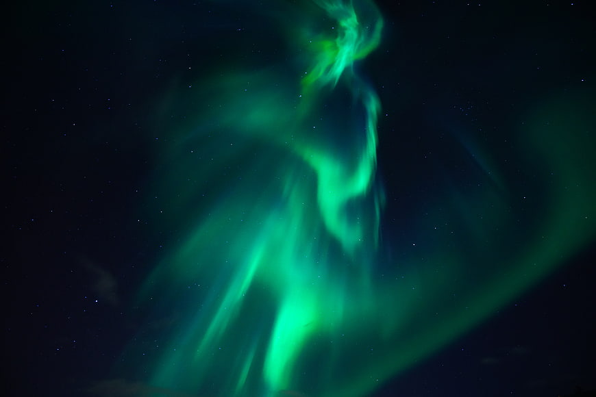 Vibrant Green Aurora Borealis in Starry Night Sky
