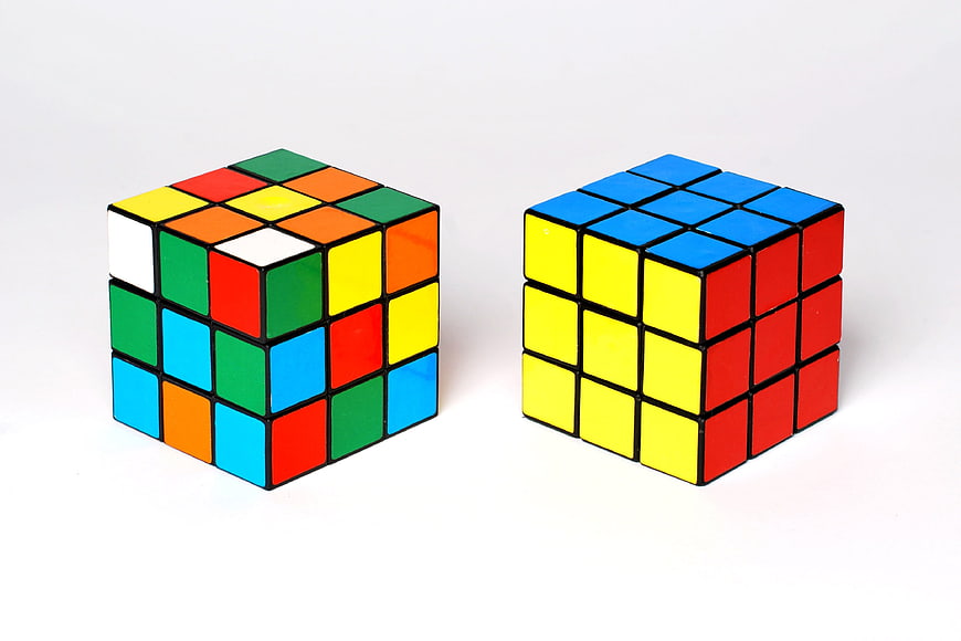 Solved and Unsolved Rubik's Cubes on White Background