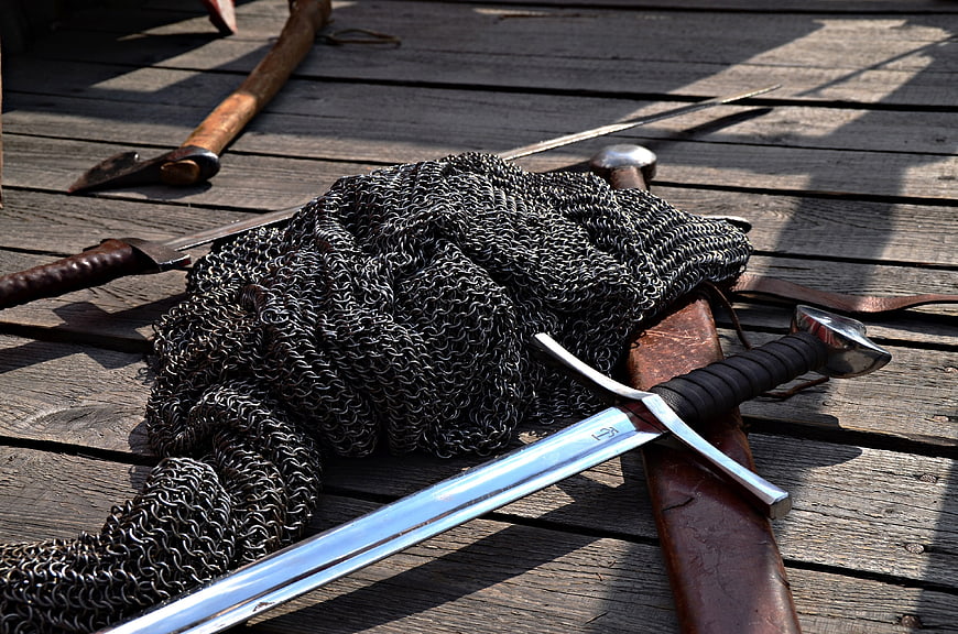 Medieval Weapons and Chainmail Armor on Wooden Deck