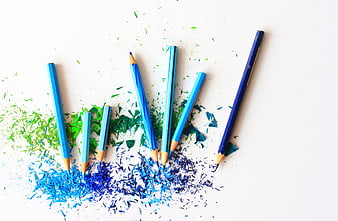 Blue and Green Pencils with Shavings on White Background