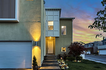Modern Green House Exterior at Sunset with Warm Lighting