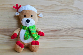 Cute Christmas Reindeer Plush Toy on Wooden Background