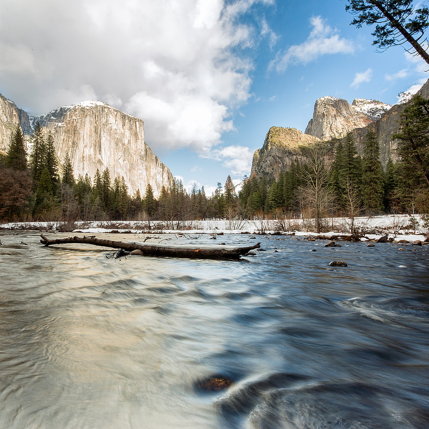 Yosemite Valley River Flow with Snow-Capped Cliffs