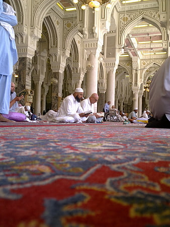 Muslim Men Reading Quran on Carpet in Grand Mosque Interior