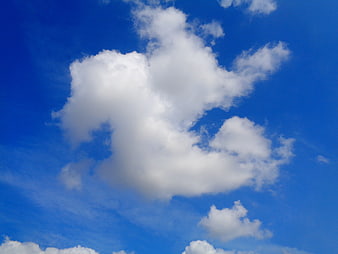 Fluffy white clouds against a vibrant blue sky