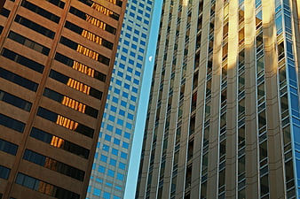 Low angle view of modern skyscrapers with crescent moon