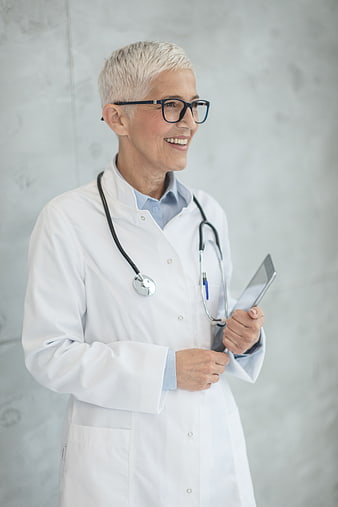 Smiling Senior Female Doctor with Stethoscope and Tablet