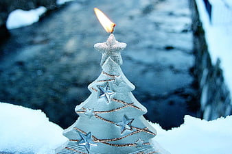 Lighted Christmas Tree Candle In Snowy Winter Landscape