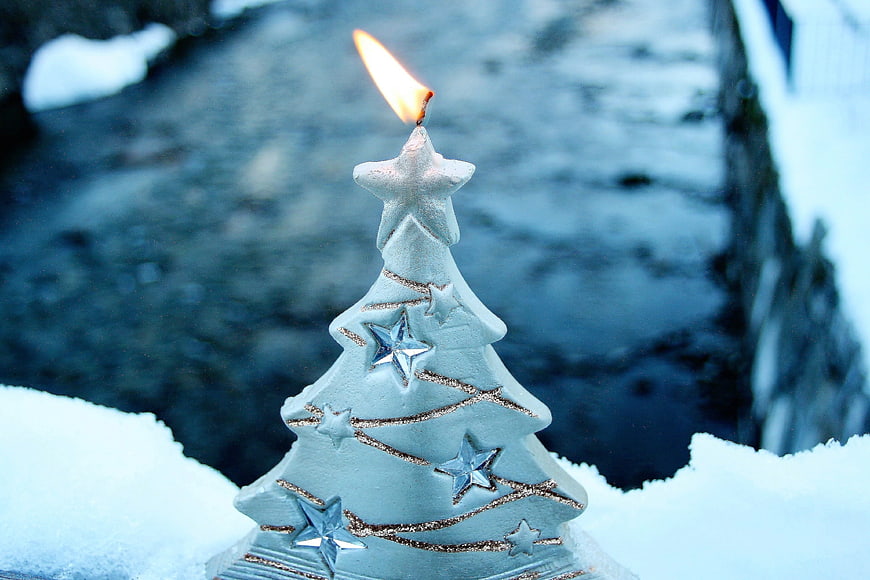 Lighted Christmas Tree Candle In Snowy Winter Landscape