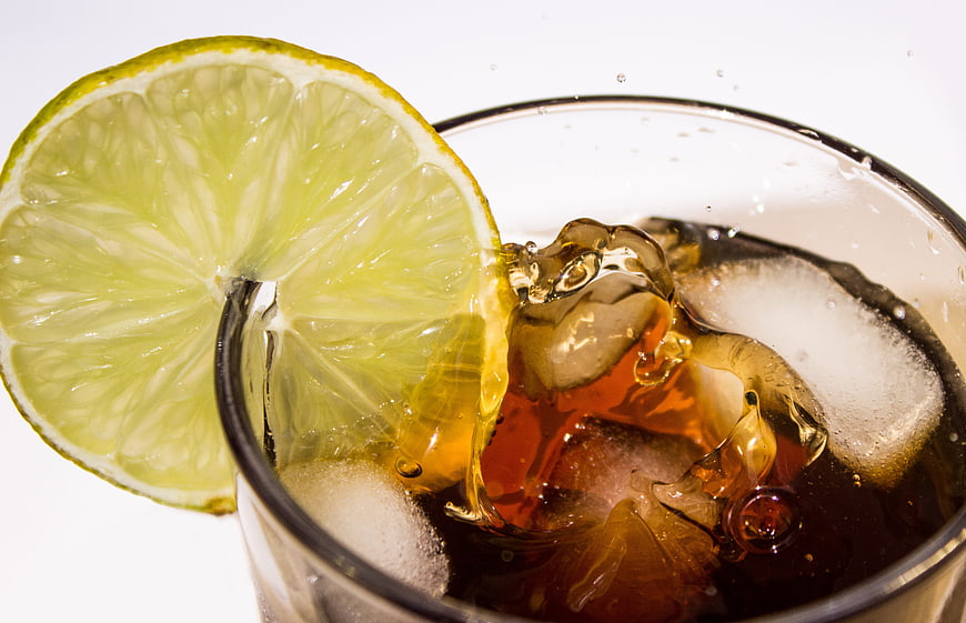Refreshing Iced Cola Drink With Lime Slice And Ice Cubes