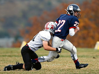 American Football Tackle Action Shot on Grass Field