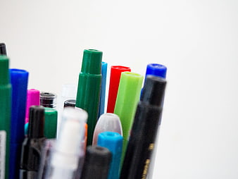 Close-up of colorful pens and markers in a container