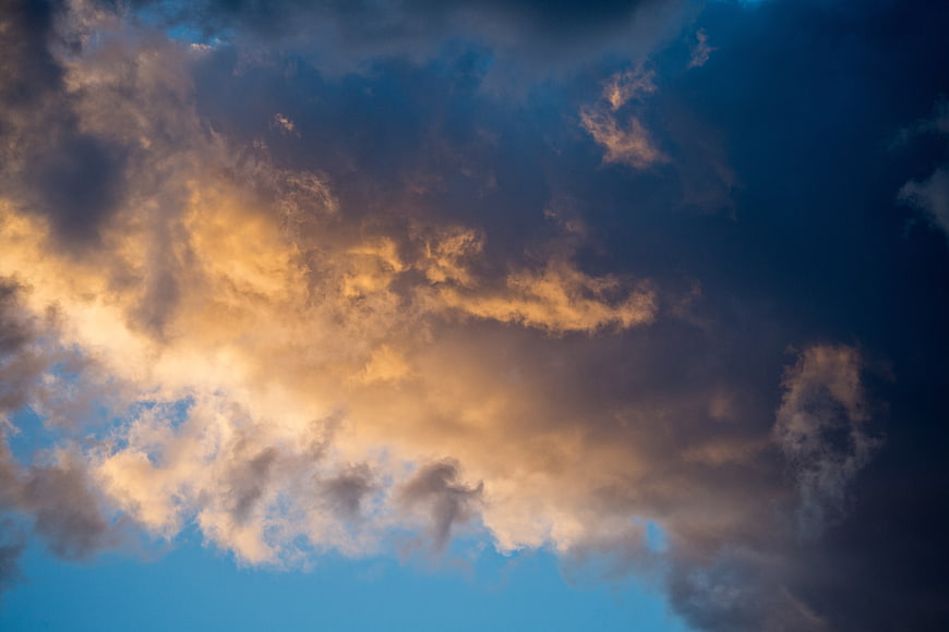Dramatic Sunset Clouds Against Deep Blue Sky