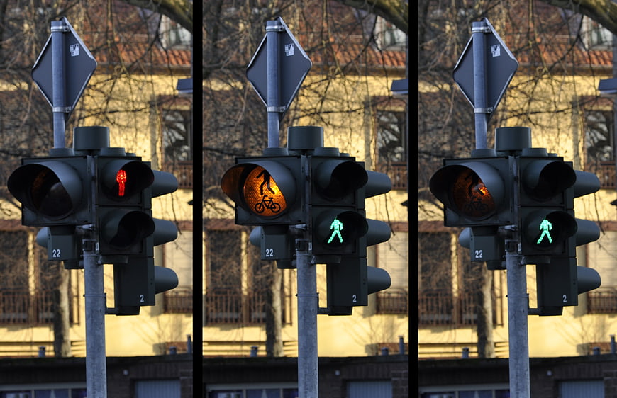 Triptych of Urban Pedestrian Traffic Signals Showing Red, Amber, and Green States