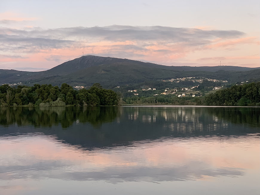 Serene Lake Reflection at Sunset with Mountain and Village