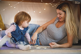 Mother and Toddler Playing Dominoes Indoors