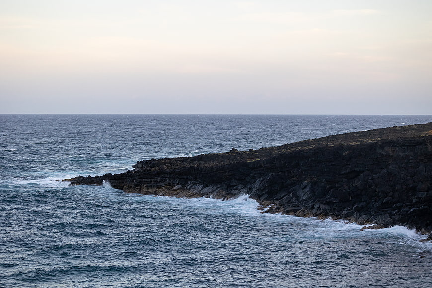 Rugged Rocky Coastline with Crashing Ocean Waves at Dusk