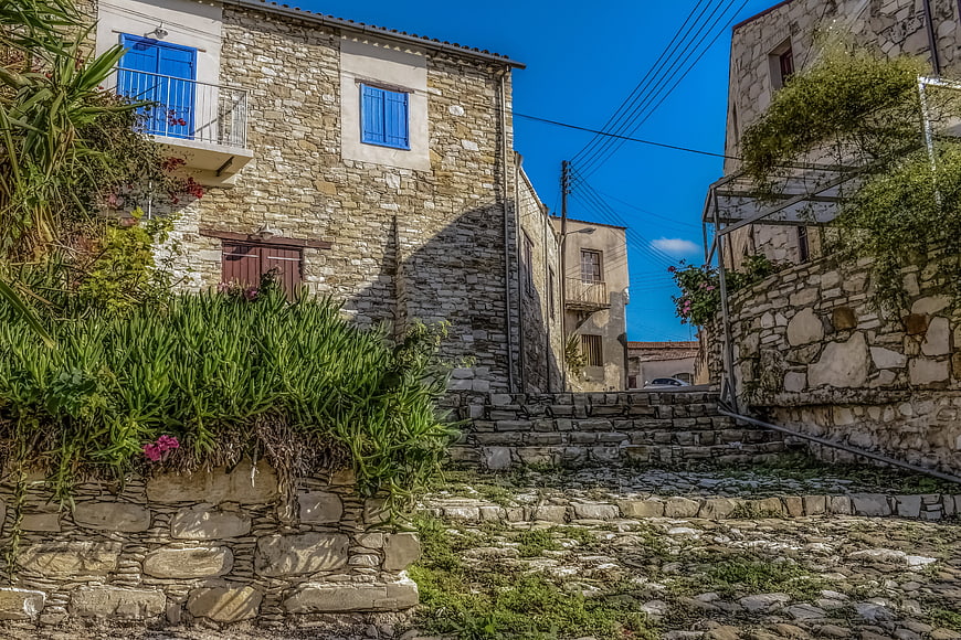 Traditional Stone Village Street with Blue Shutters and Stairs