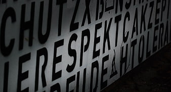 Close-up of graffiti text reading respect and tolerance on wall