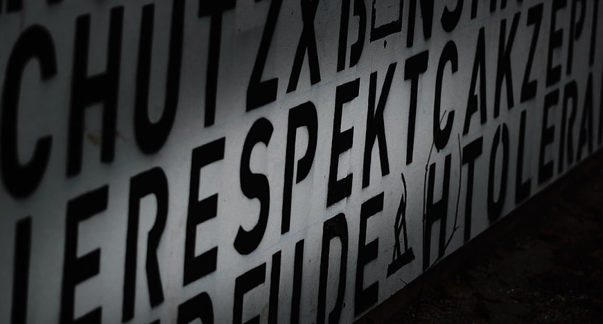 Close-up of graffiti text reading respect and tolerance on wall