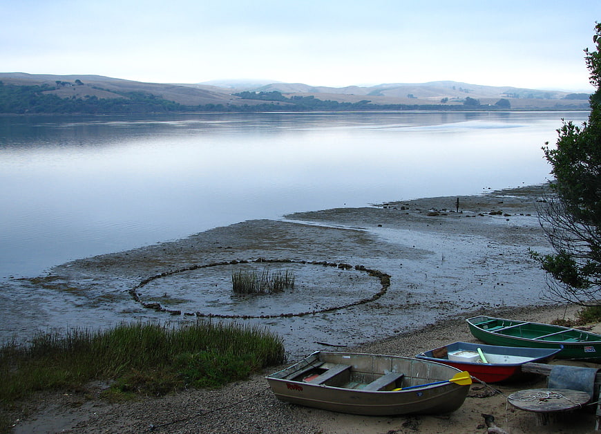 Stone circle on lake shore with rowboats