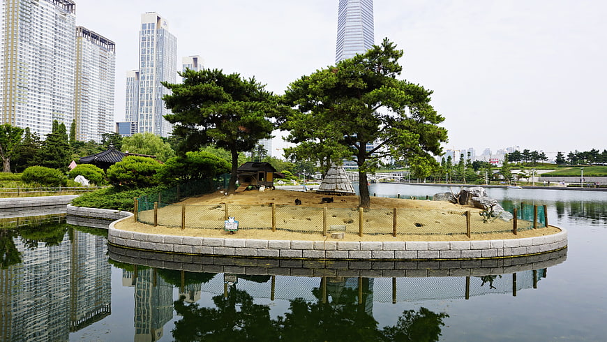 Traditional Korean Pavilion on Island in Urban Park Lake